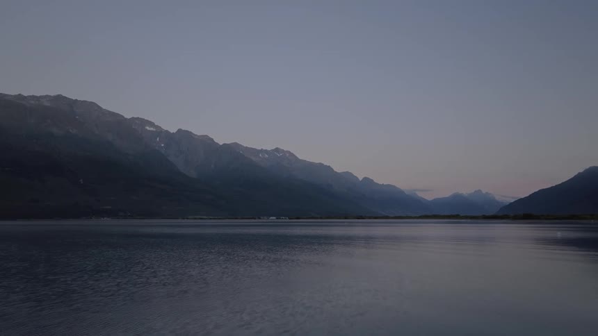 Landscape of a lake at dawn with mountains around