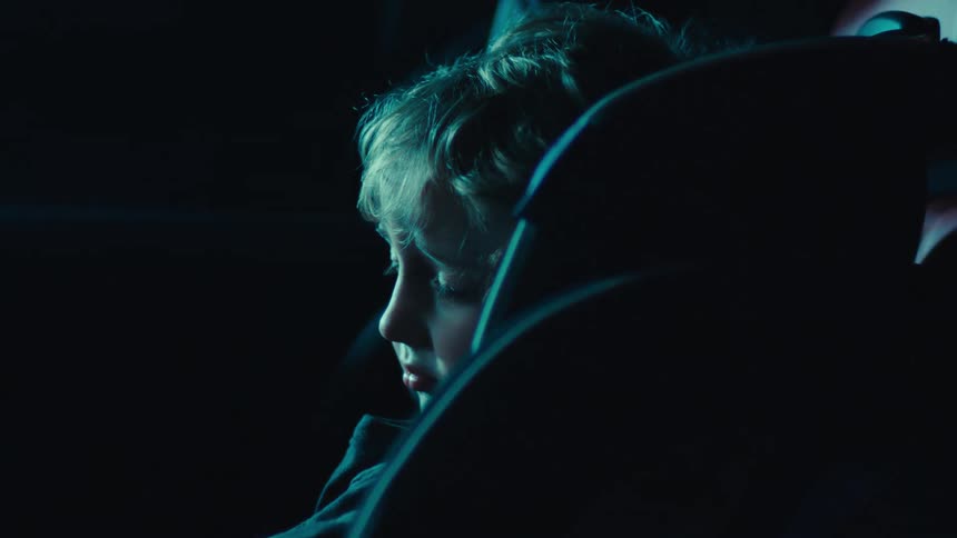 A footage of a kid sleeping in a car