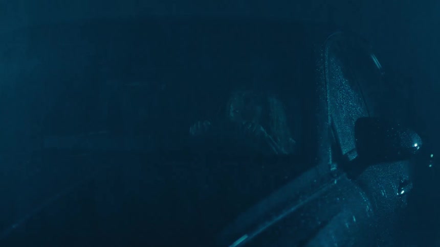 Woman inside a sedan vehicle on a rainy day