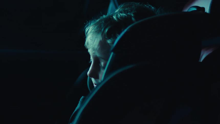 Small child sleeping in car seat in back seat