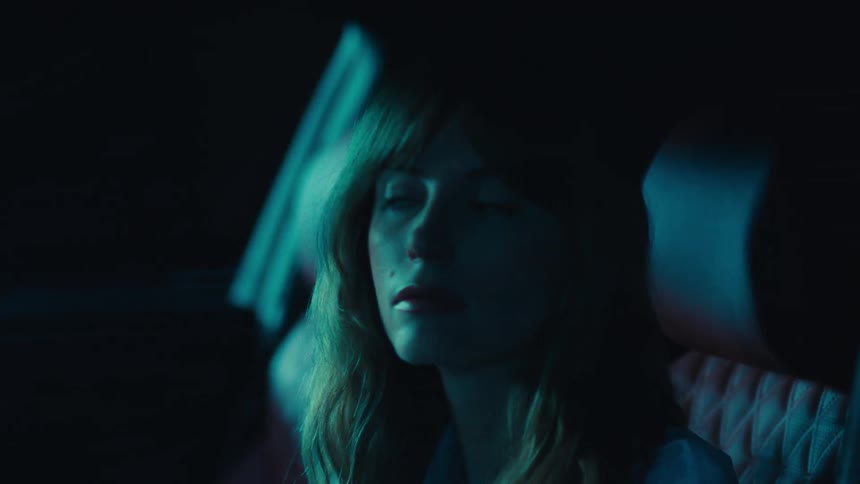 Portrait of a blonde woman inside a car