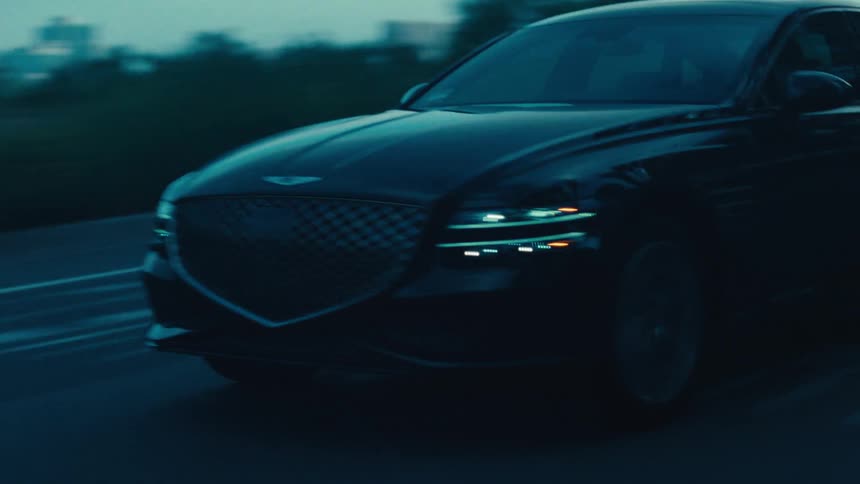Black sedan vehicles traveling on a road