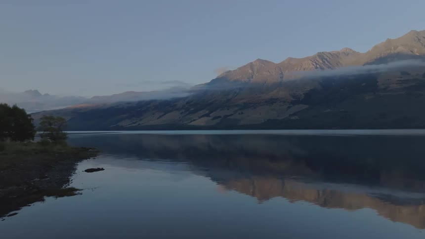 Calm lake with mountains in the background