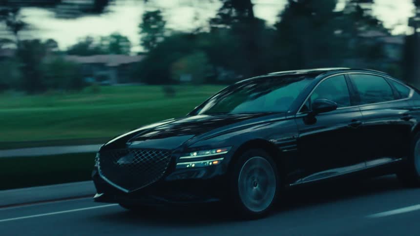 Black sedan car changing lanes on a highway