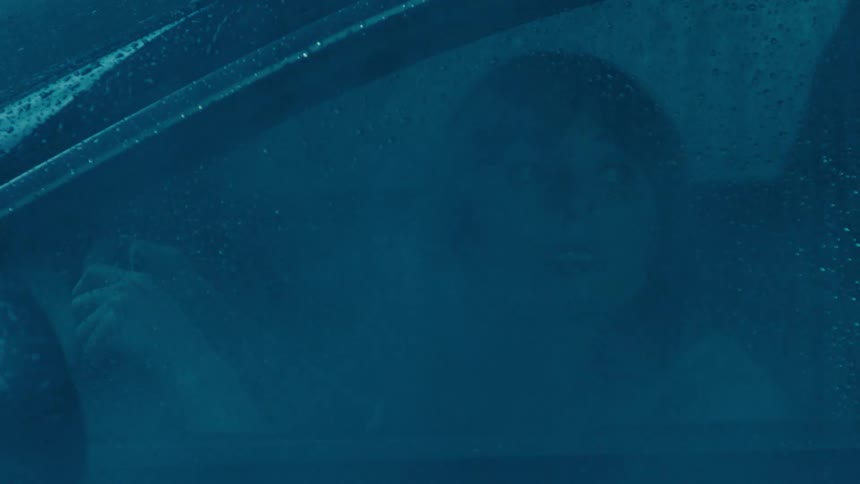 Woman inside a car on a rainy day