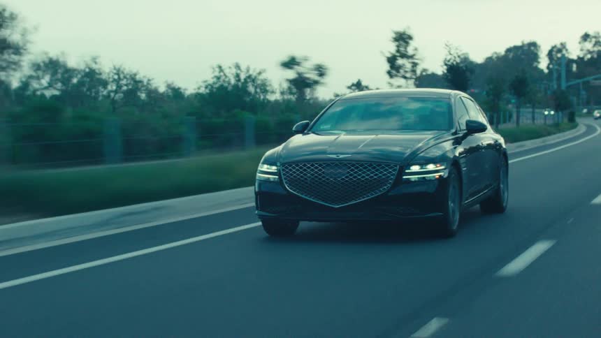 Black sports car traveling on a highway