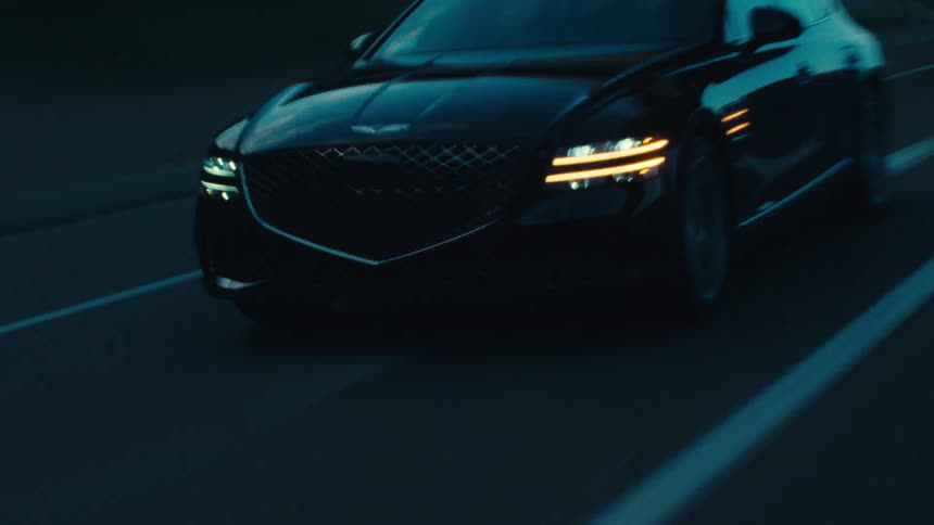 Black sedan vehicle moving on a highway