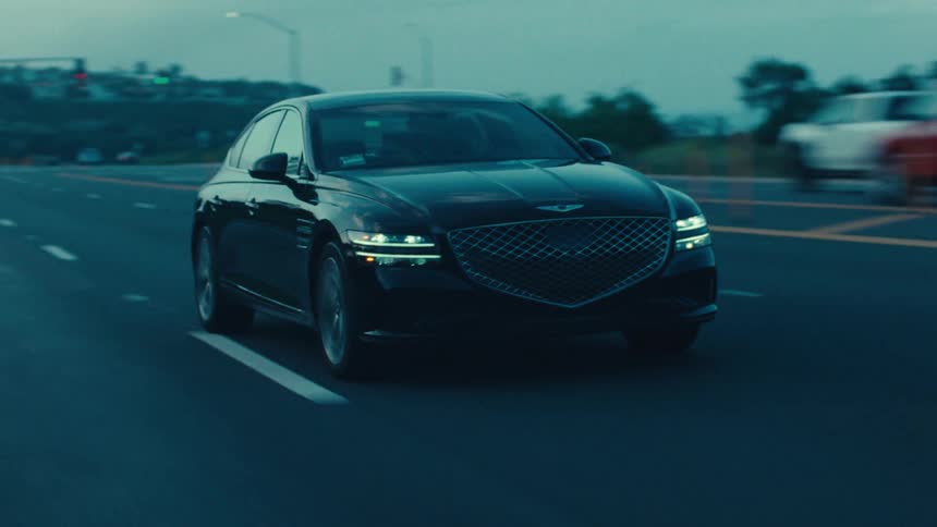 Black sedan car giving turn signal and changing lanes on highway