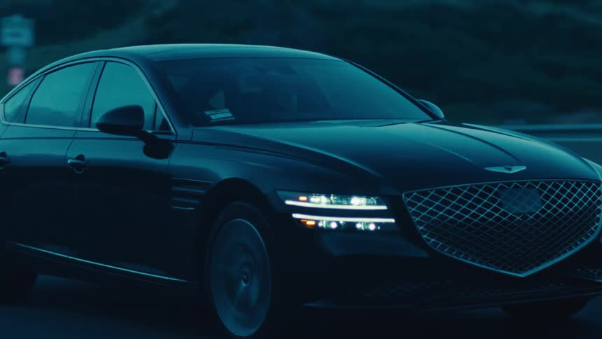 Black sedan car traveling on a highway