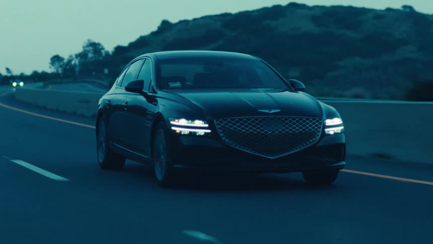 A luxury sedan is traveling on a highway