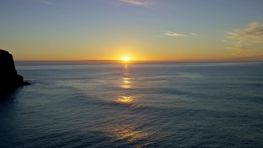 Sun reflecting off the water across the horizon at sunrise