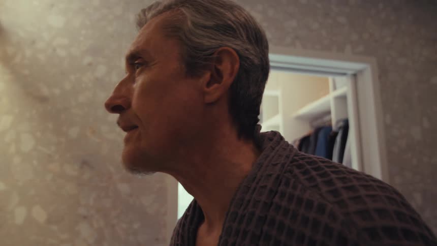 Man shaving with electric razor and happy with results