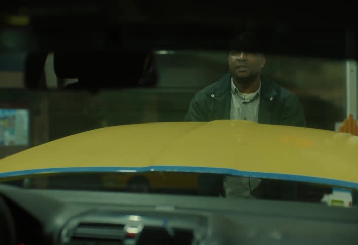 A footage of a man closing a car burnet