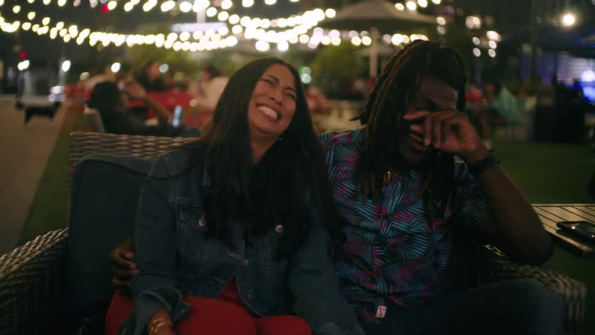 Two friends talk and laugh at night