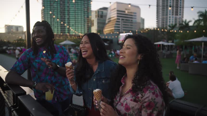 Friends eat ice cream and drink outdoors