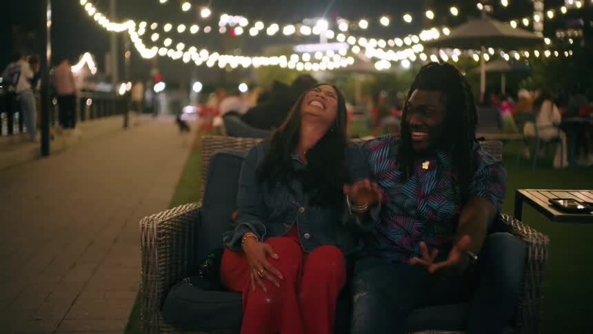 Friends chatting with a cheerful girl on a good night