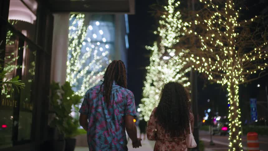 A footage of a lady and a man walking the street