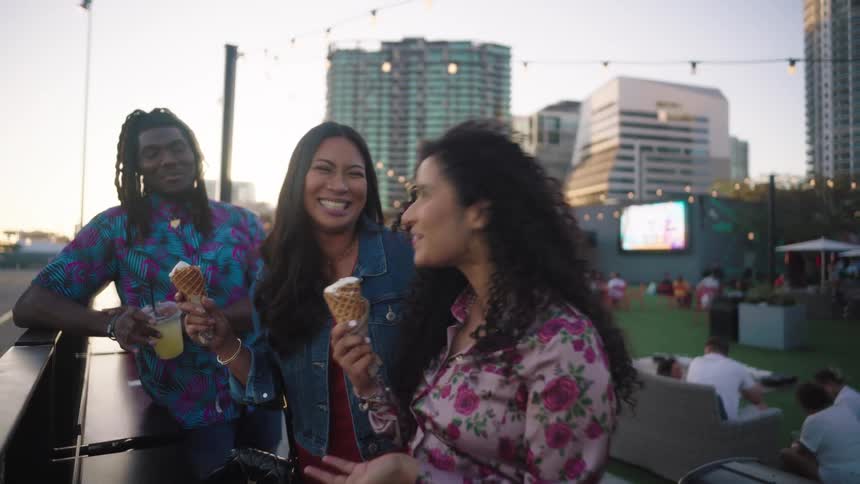 Friends eating ice cream and drinking in an outdoor setting
