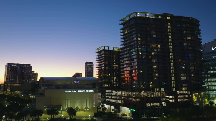 Buildings of a metropolis illuminated at nightfall