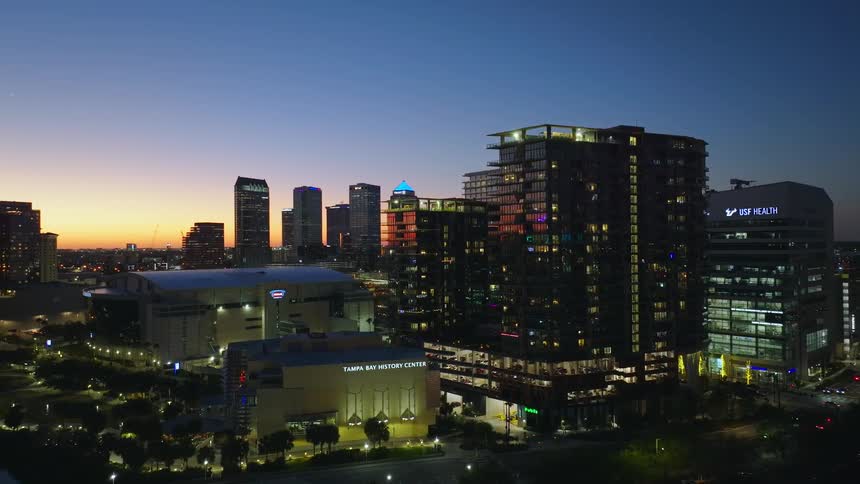Aerial view of a modern illuminated metropolis at dusk