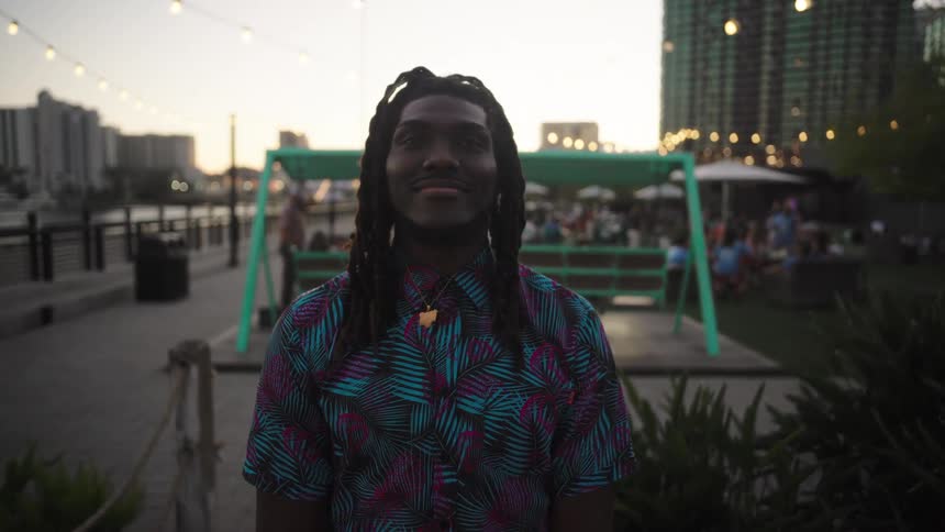 Man with happy facial expression in an outdoor bar setting