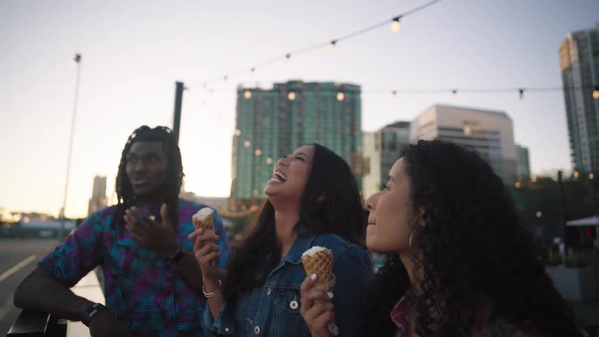 Women laugh and eat ice cream
