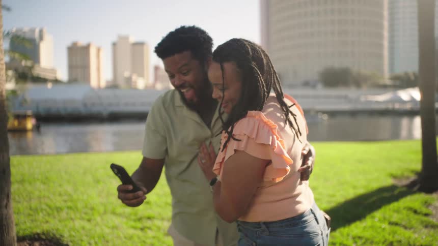 A footage of a couple taking a selfie at the park