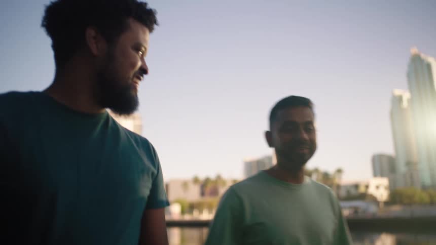 A footage of men walking beside the lake