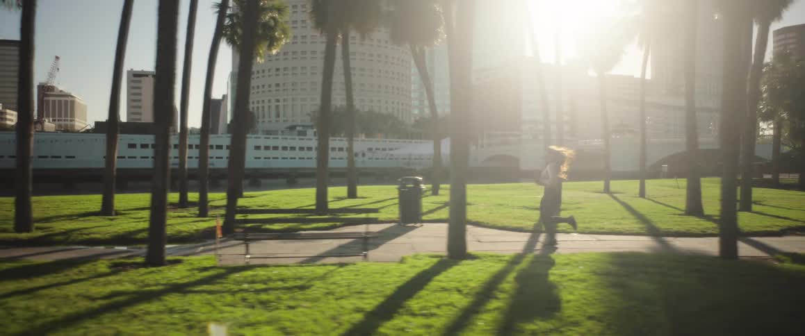 Woman jogging on a path at a park in the city