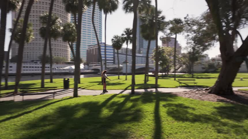 Woman rollerblading through a treelined square