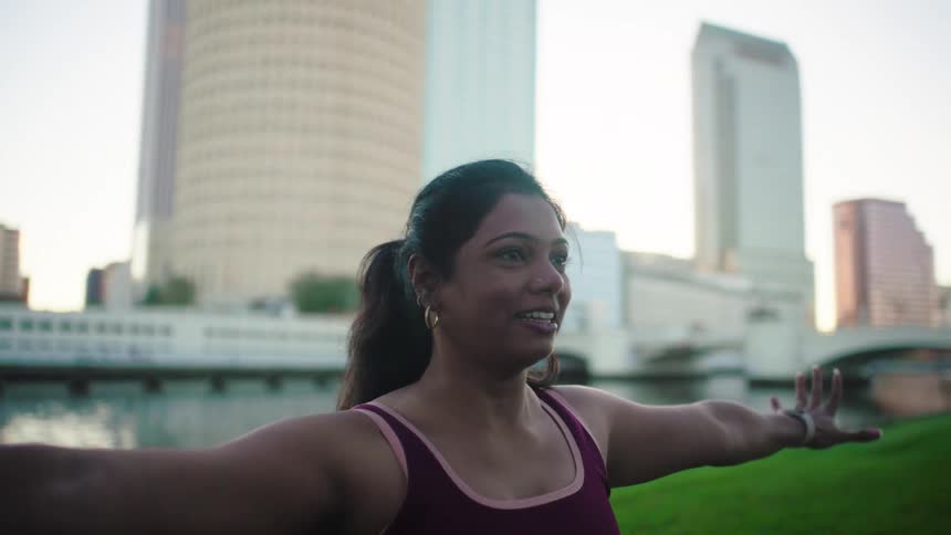 A woman is doing yoga on the grass