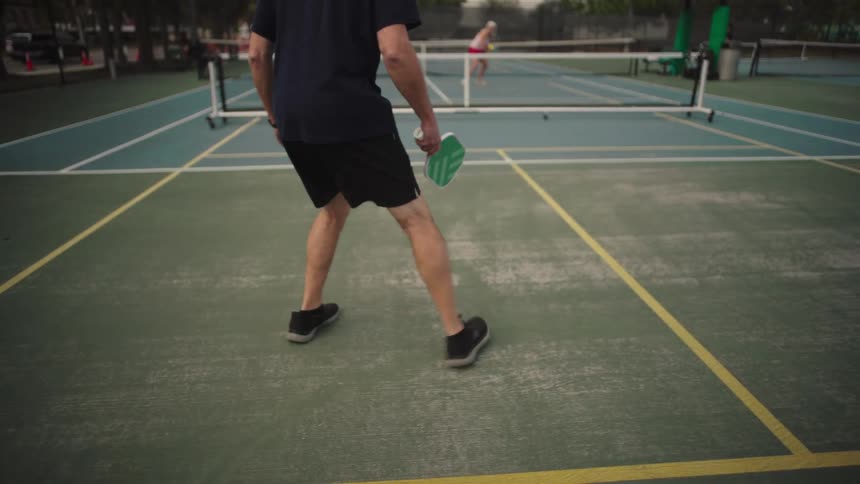 Person on a court playing pickleball