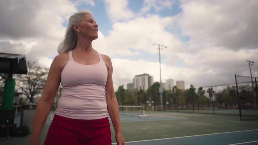Woman with a pickleball racket and ball