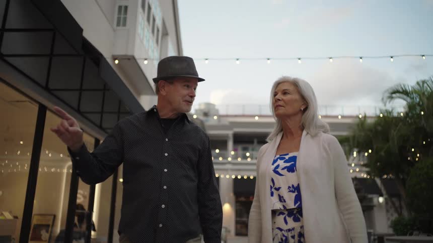 Couple walking together in a shopping and restaurant environment