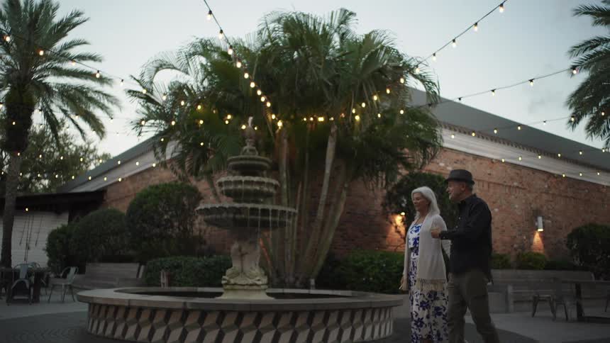 Elderly couple holding hands walking outdoors