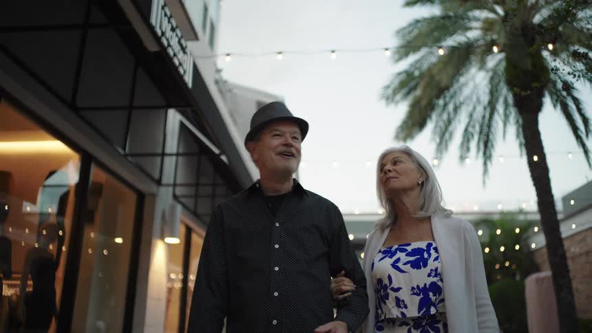 Couple walking together through a gallery in the late afternoon