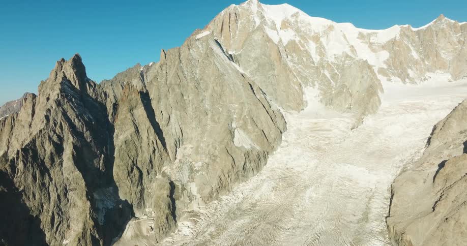 Clear skies are above the tall mountain