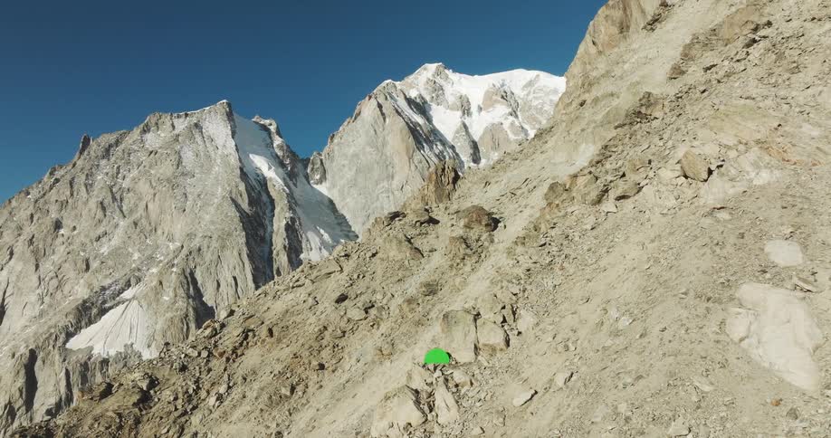 A tent nestled in the mountains