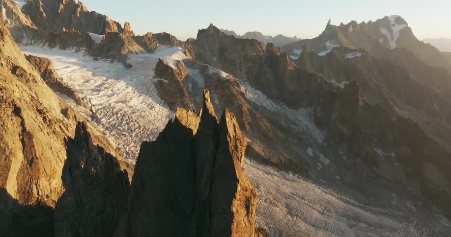 Aerial of a glacier and steep rocky peaks in a mountain range