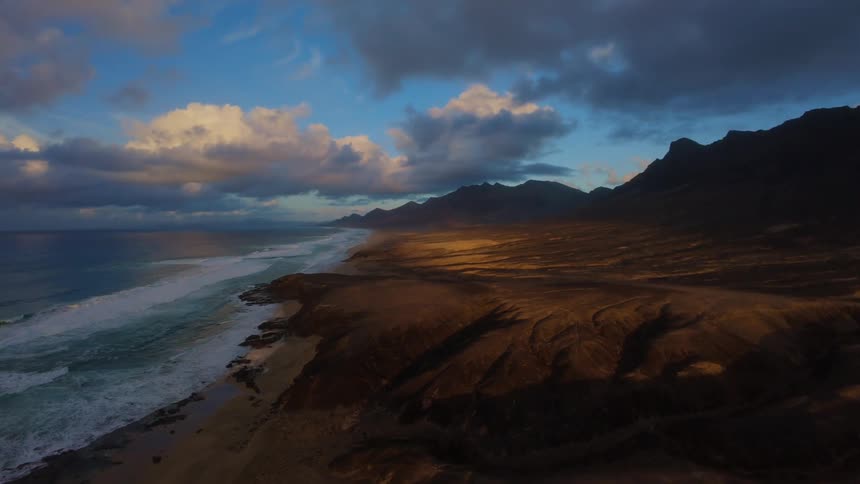 The mountains line the shade covered shore