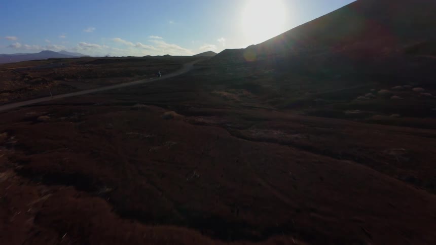Aerial view of a long highway amidst a mountainous landscape