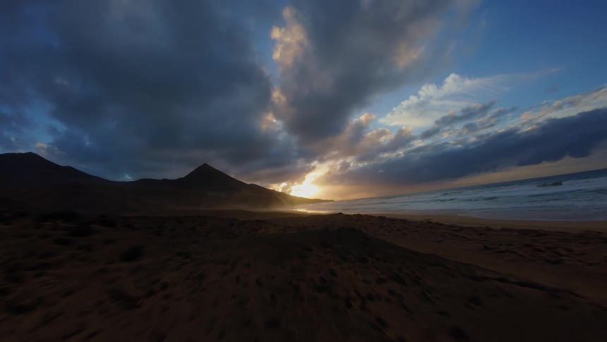 Landscape of a beach at dawn with clouds