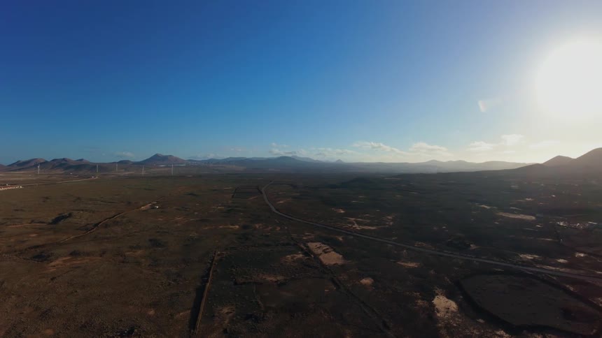 Aerial panorama of a large area of land with mountains on the horizon