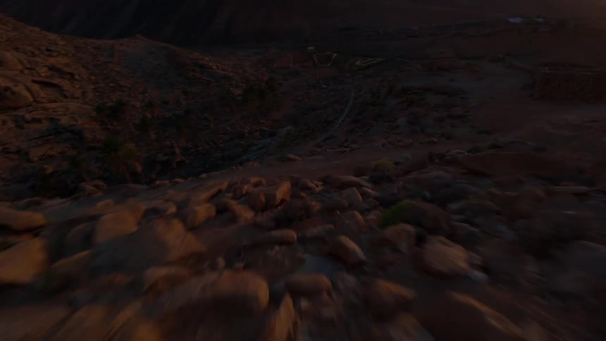 A rugged rocky hillside landscape bathed in warm muted tones