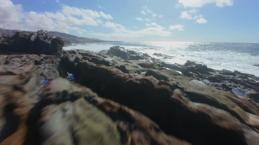 The tide moves over the rocks on the coast