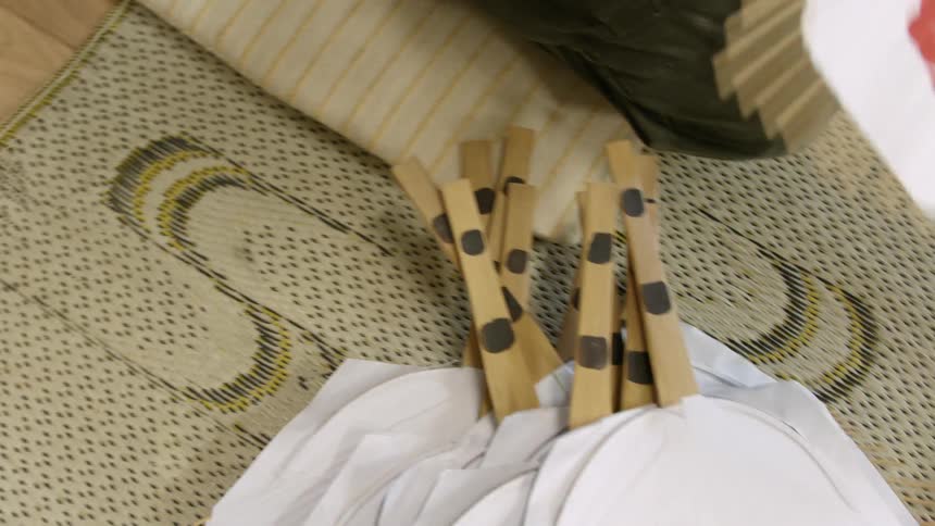 A  person is making hand held paper fans