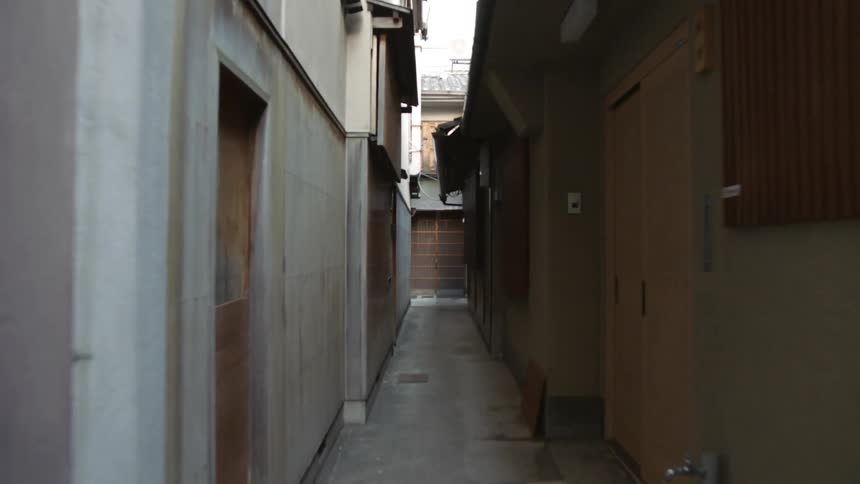 Moving through a dark corridor to a metal barred door