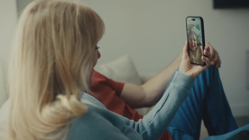 A footage of a man and a woman making a video call in a room
