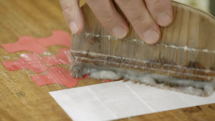 Person smearing glue onto a project