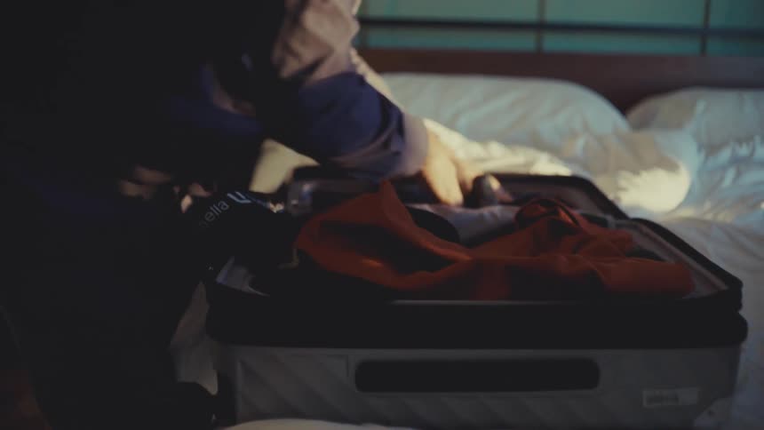 A footage of a man packing his luggage